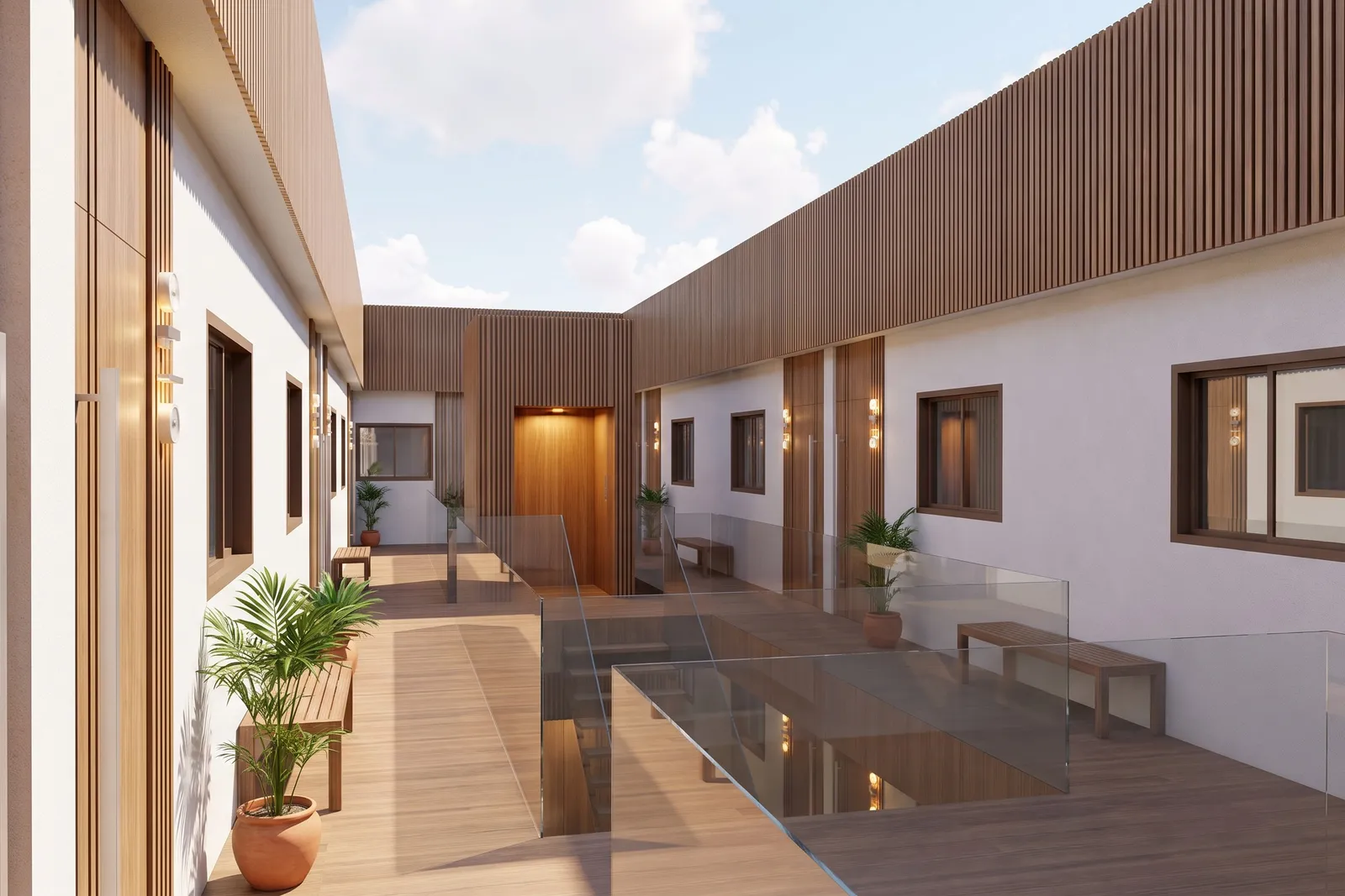 Wewnętrzny ciąg komunikacyjny patio w Thalassa Living z drewnianym tarasem, szklanymi balustradami, roślinami w donicach i drzwiami do poszczególnych mieszkań.