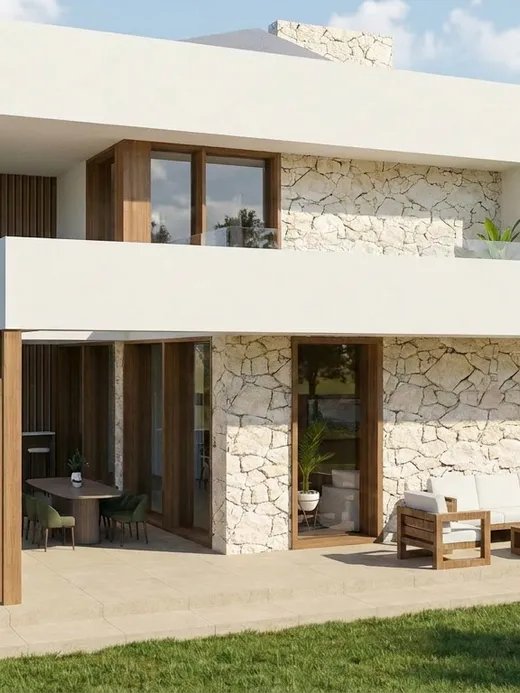 Rear facade of Brisa villa with a stone accent wall, timber-clad columns, and a covered terrace lounge opening onto the garden.