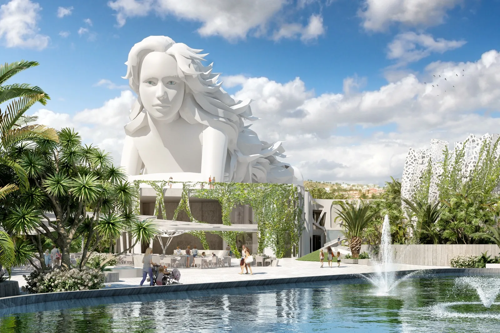 Una escultura blanca monumental de la cabeza y los hombros de una mujer que se alza sobre una plaza ajardinada con palmeras y fuentes.