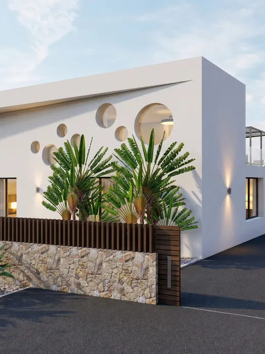 Street-side view of Mantillo villa's white sculptural facade with round window openings and tropical landscaping.