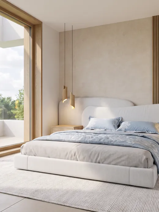 Primary bedroom with a sculptural corner window, a curved upholstered headboard, blue patterned bedding, and a private balcony beyond.