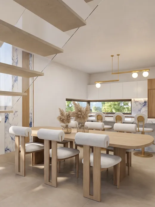 Dining area beneath a floating staircase, with an oval oak table, bouclé chairs, a brass pendant light, and the kitchen island visible beyond.