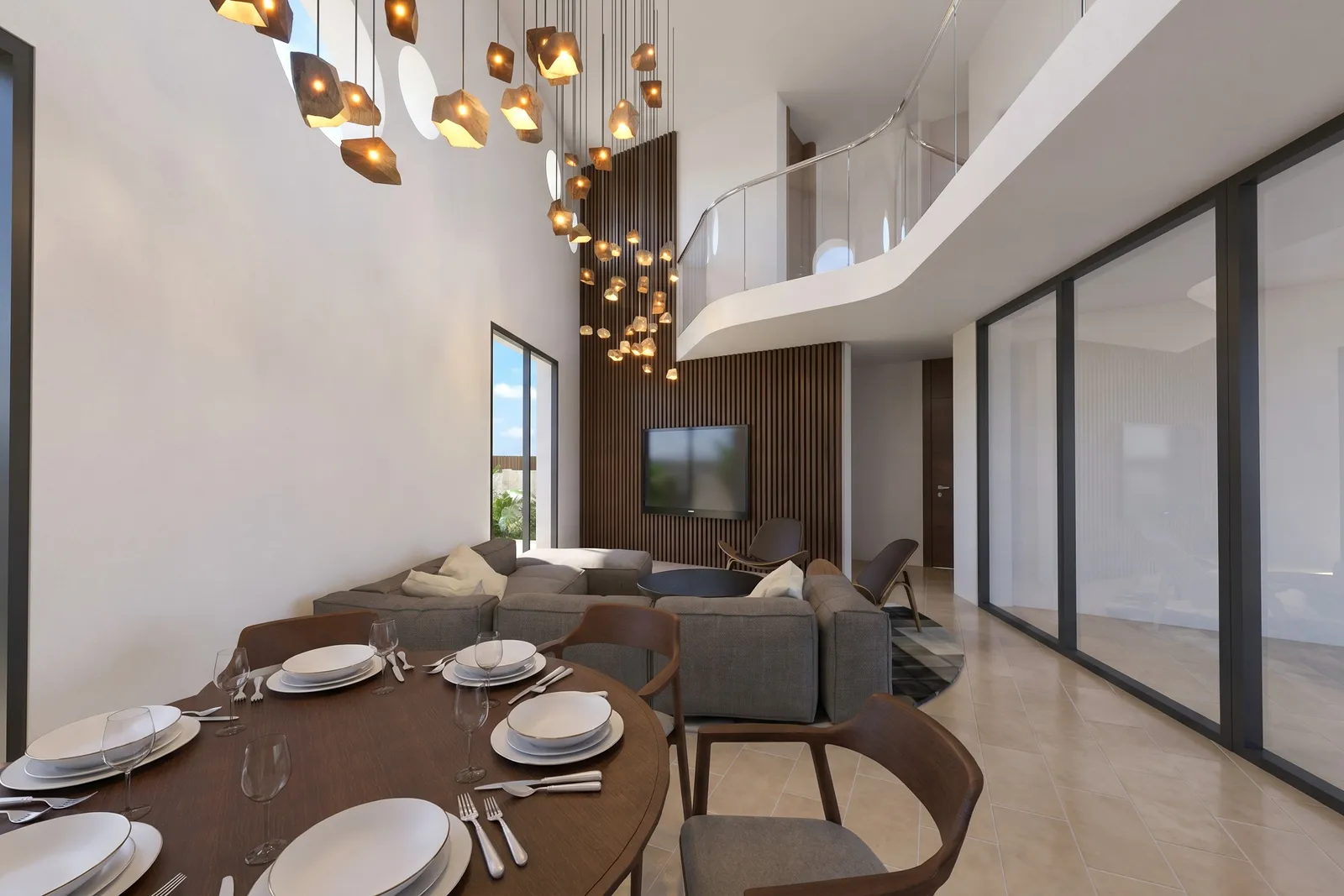 Comedor y salón de doble altura con una instalación escultórica de lámparas colgantes y una pasarela en la planta superior.