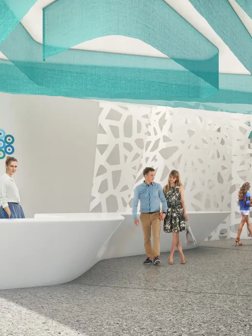 Reception area with turquoise ribbon ceiling detailing and a perforated white screen.
